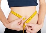 Women measuring slim wais